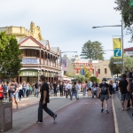 Image of South Terrace in Fremantle with crowds lining either side of the street with heritage buildings in the back ground.